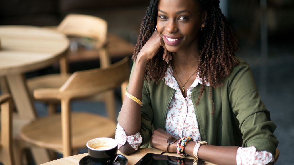 Indoor portrait of smiling African woman.