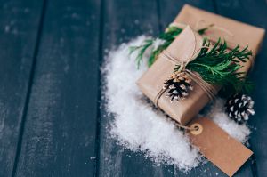 Wrapped Christmas gifts with pine cone, fir and fake snow decoration
