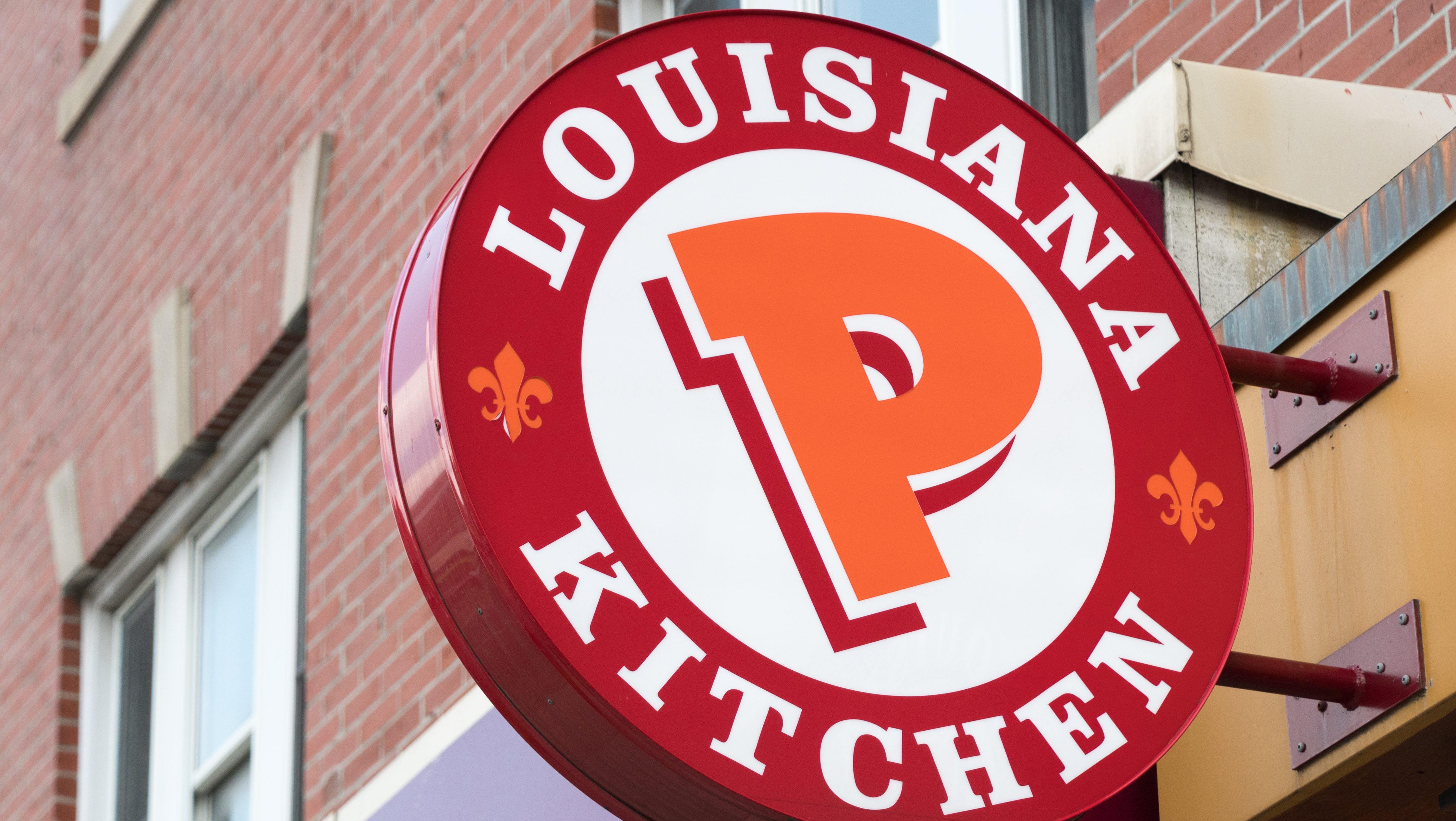 Popeyes Lousiana Kitchen sing or logo outside a restaurant...